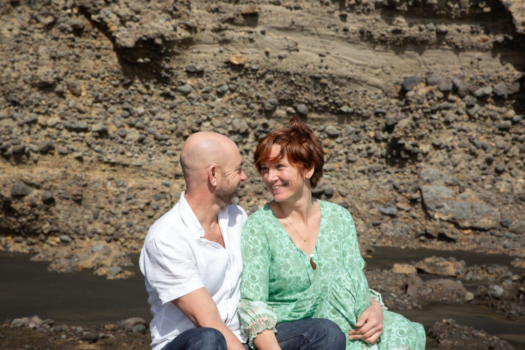 Mark and Tarisha sitting together, smiling at each other