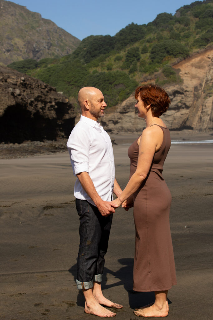 Mark and Tarisha standing face to face, holding hands