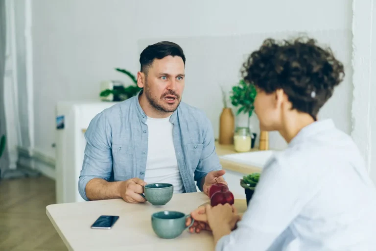 Man listening closely to his partner at the table