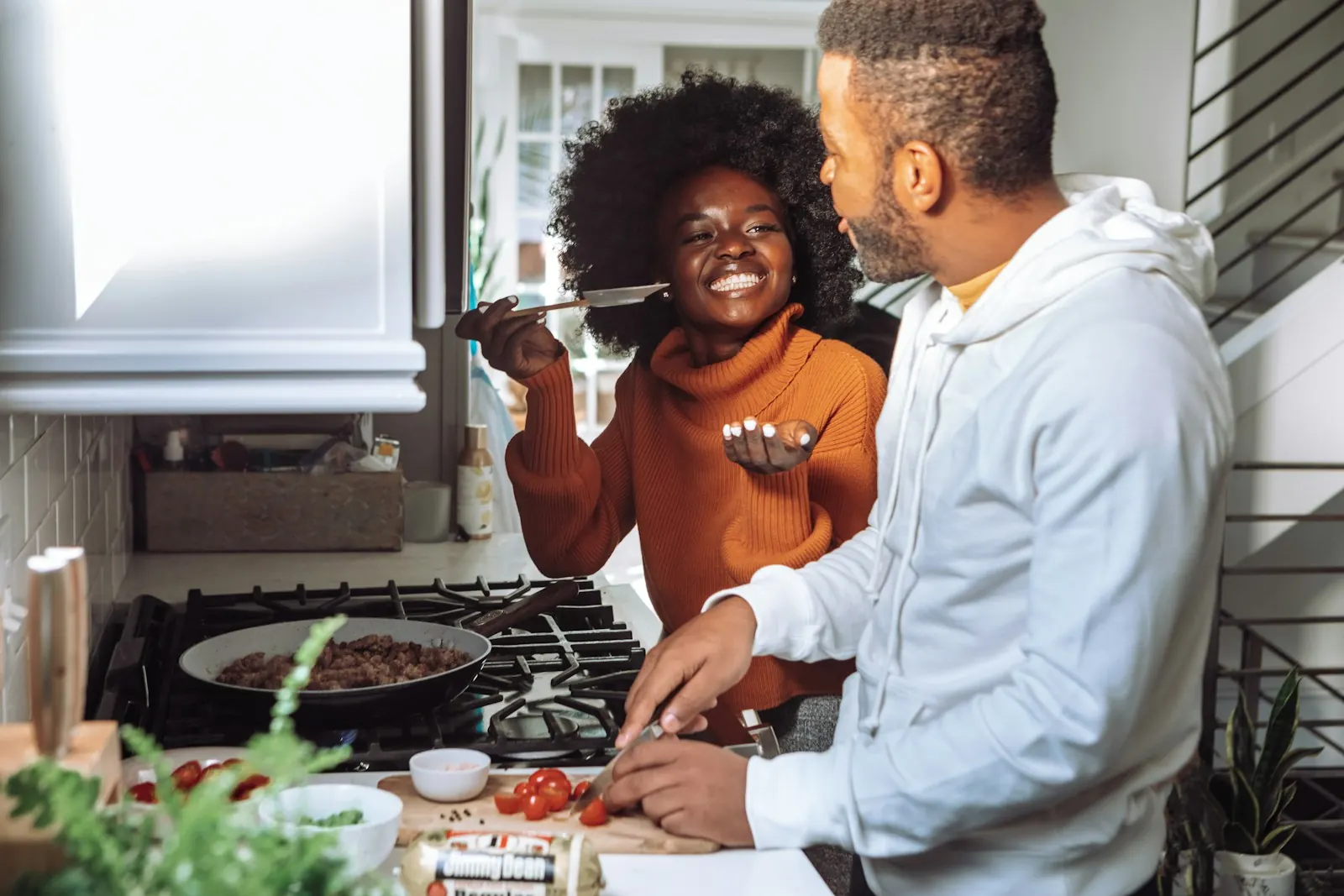 Couple laughing while cooking together