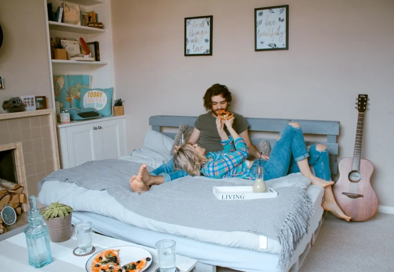 Couple laughing and playing on the bed