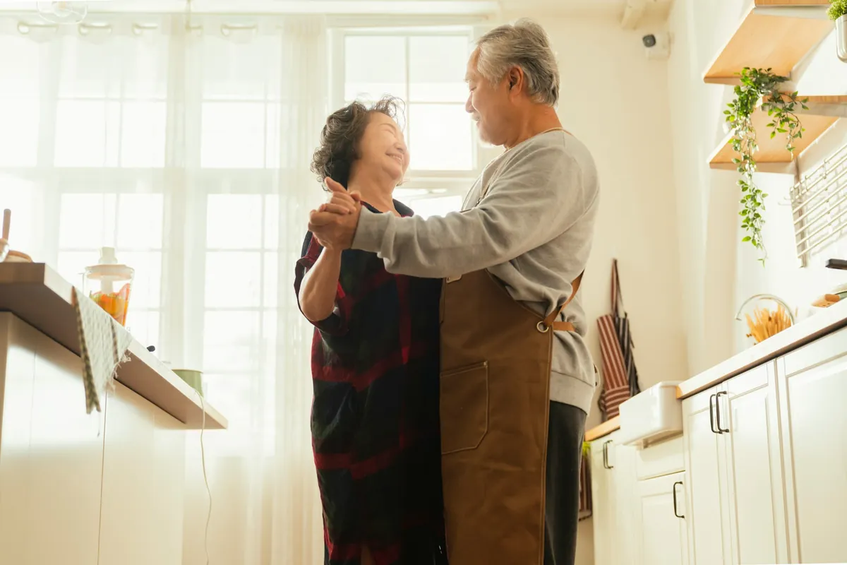Couple dancing together at home