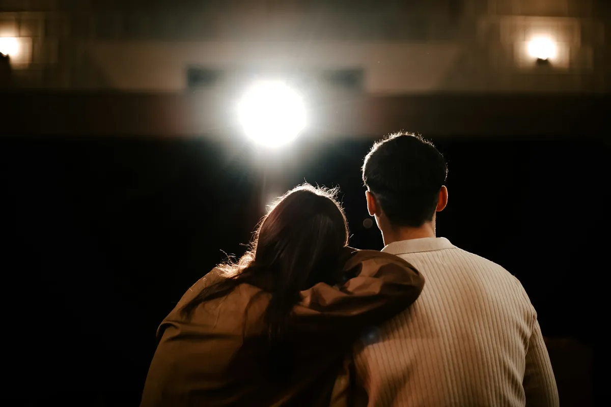 Couple from behind arm around shoulders in warm light