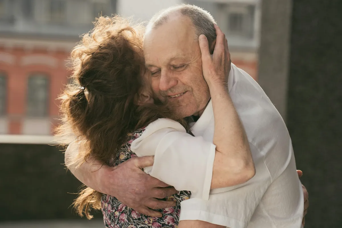 Couple holding each other close