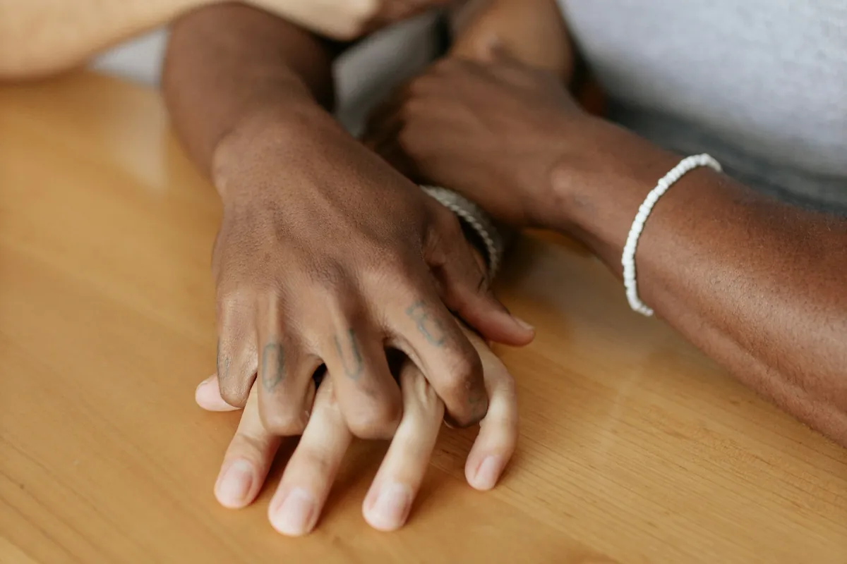 Couple holding hands across a table
