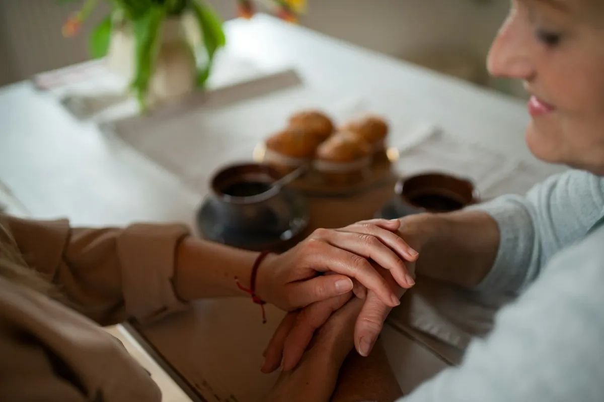 Couple holding hands across a table