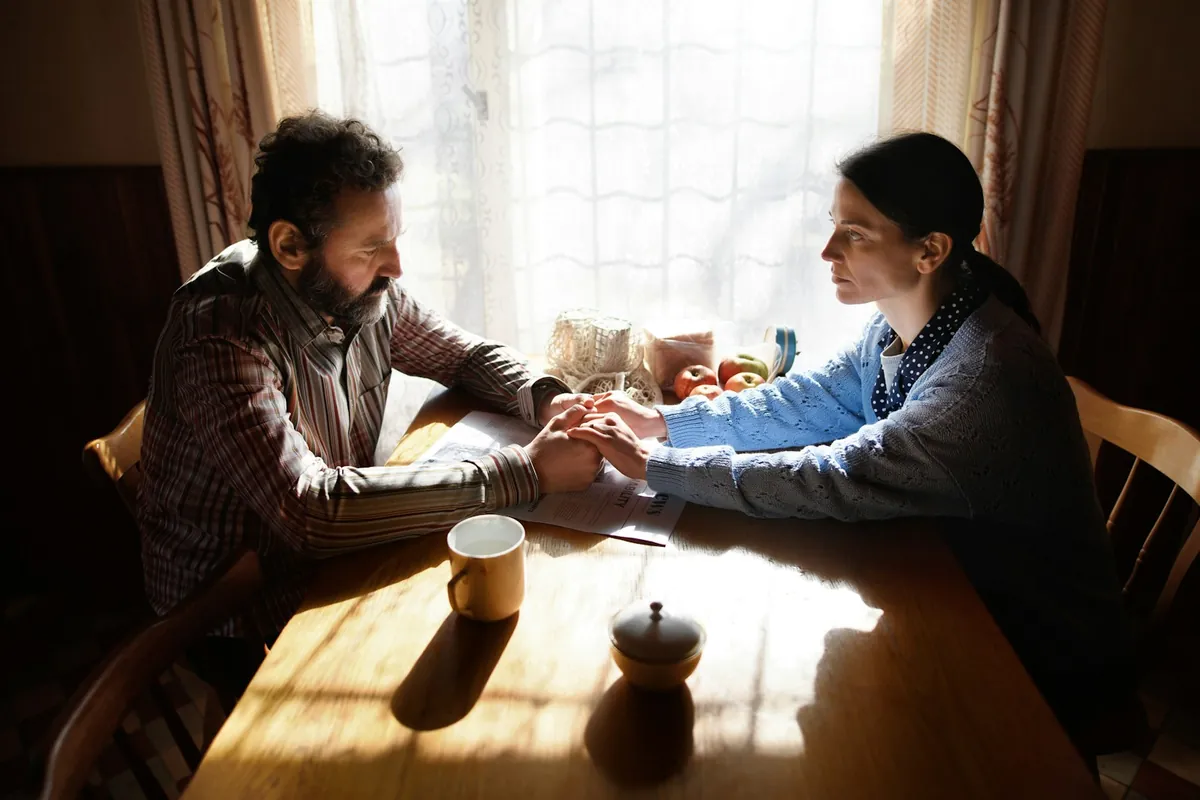 Couple holding hands across a table