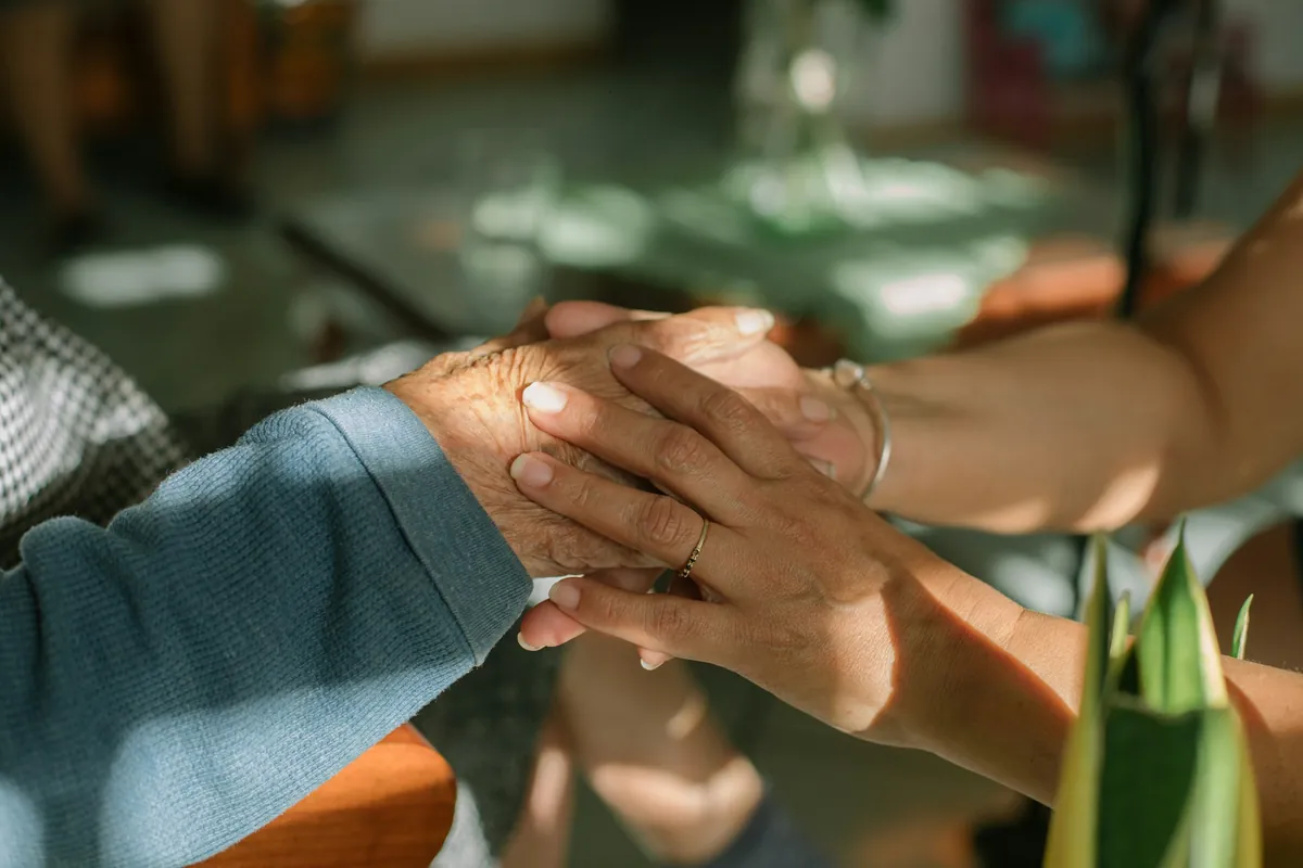 Couple holding hands across a table