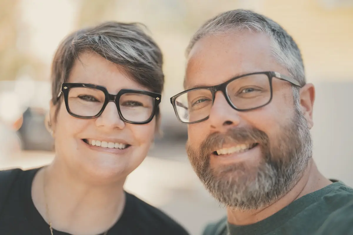 A couple in their forties smiling together