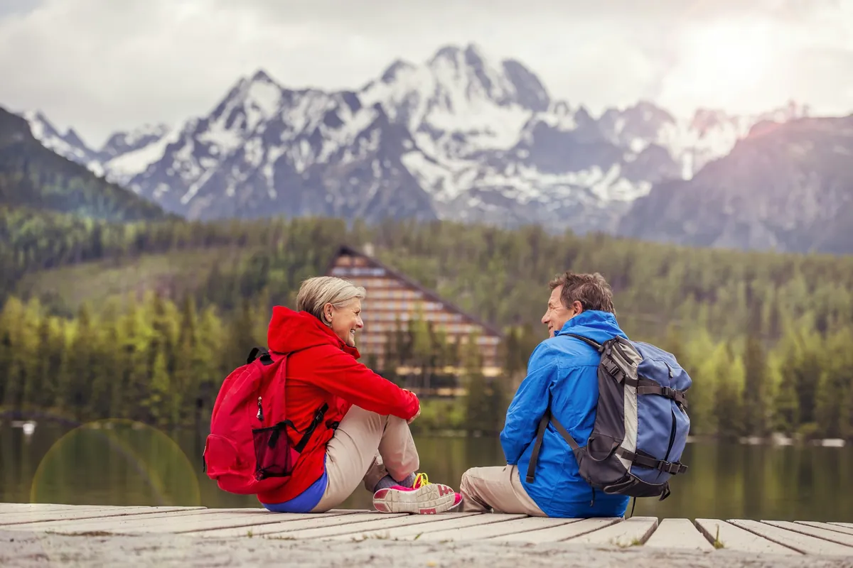 Couple sitting together by a lake