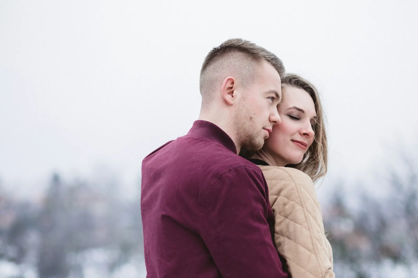 Couple cheek to cheek outdoors