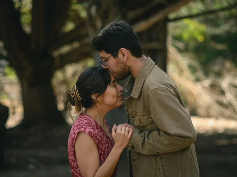 Man kissing his partner on the forehead