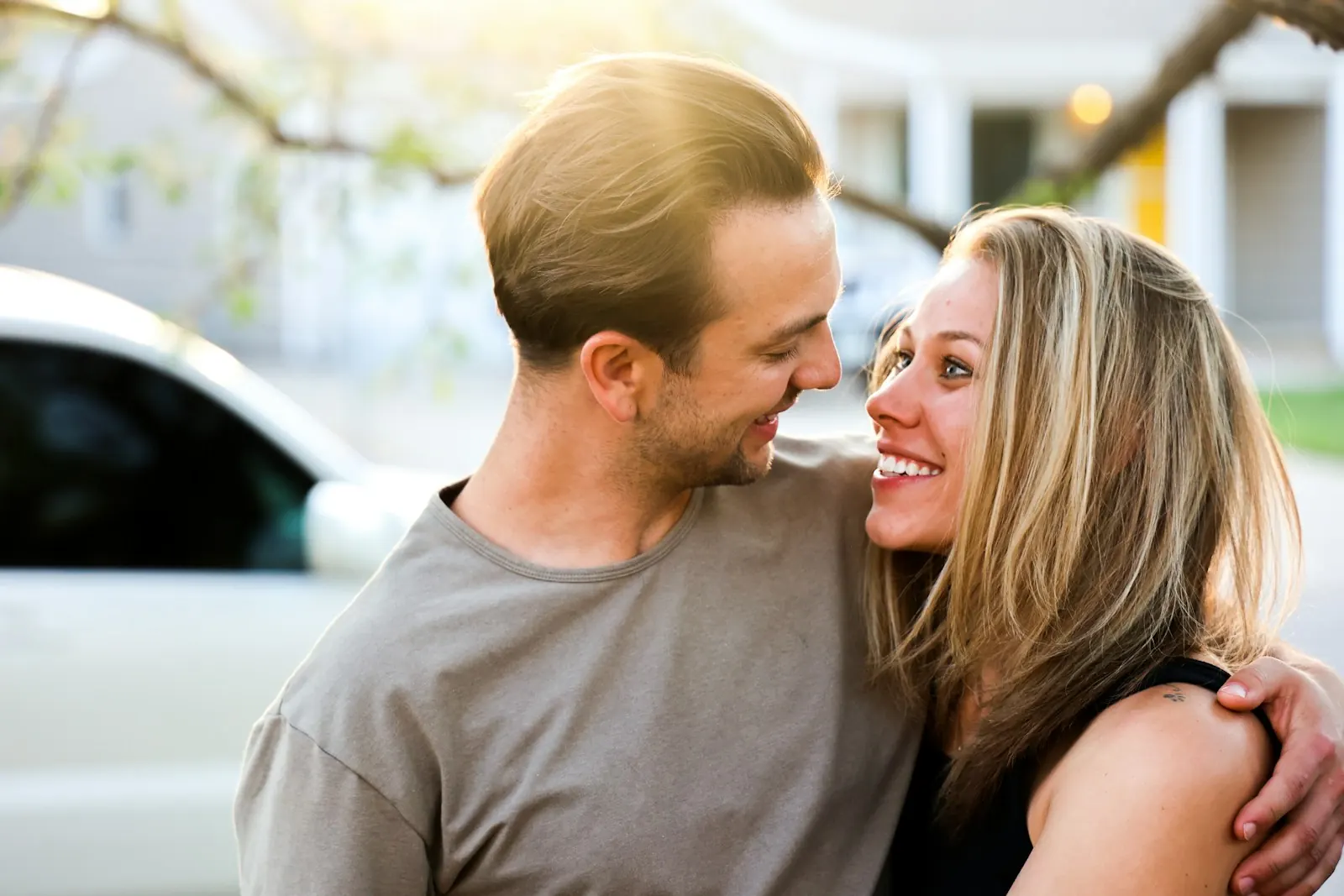 Couple laughing in a close embrace
