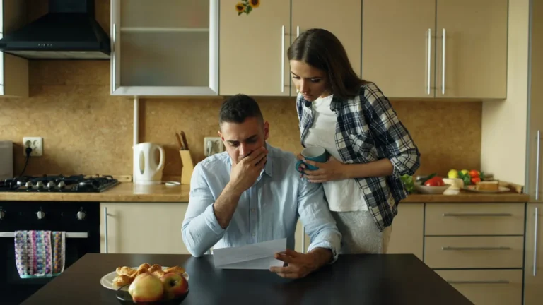 Couple stressed over bills at the kitchen table