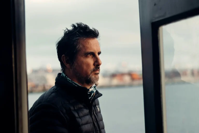 Man looking out of the window, thinking