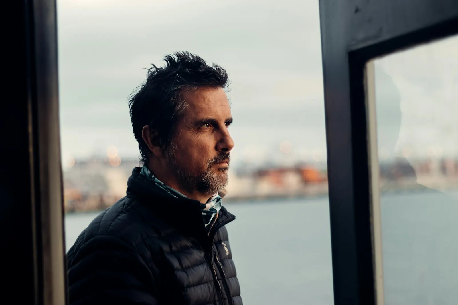 Man looking out of the window, thinking