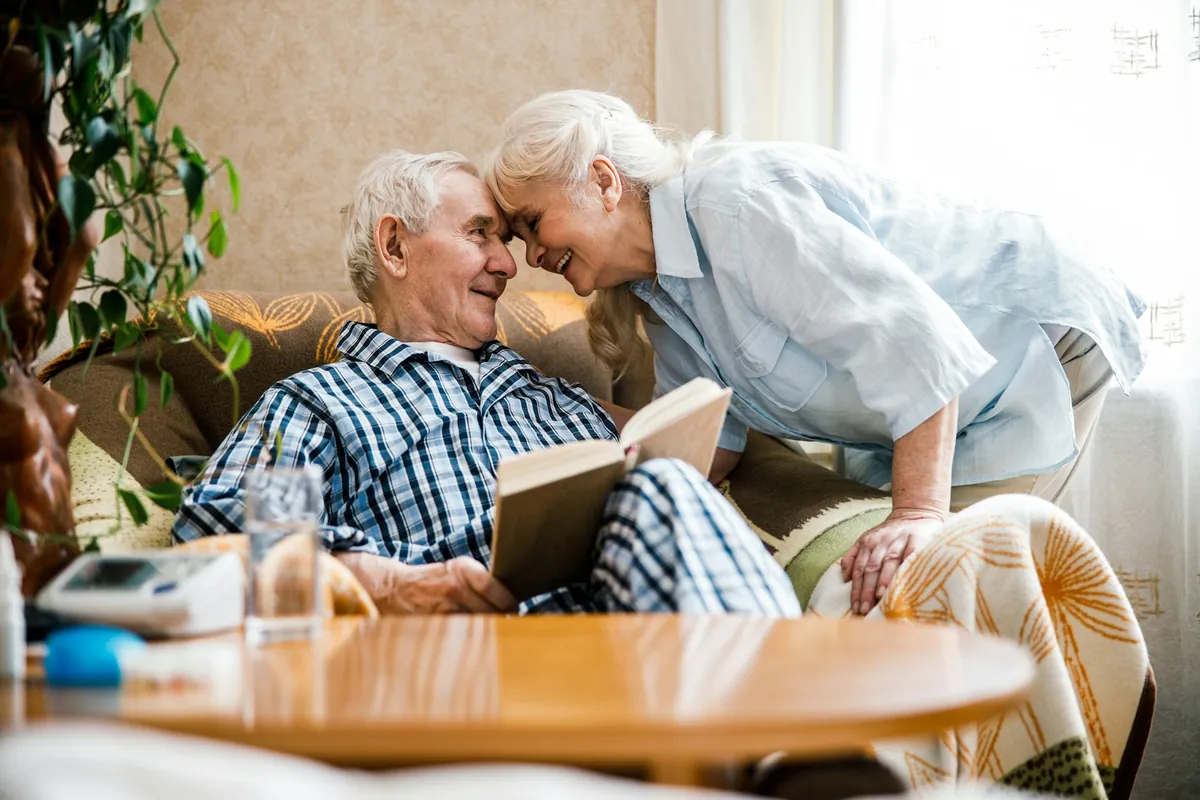 Older couple sharing a tender moment on the sofa