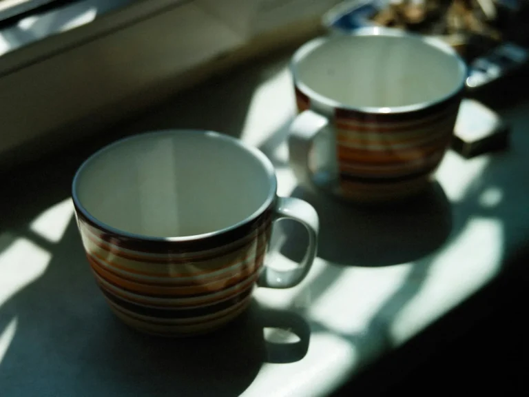 Two mugs on the kitchen bench at the end of the day
