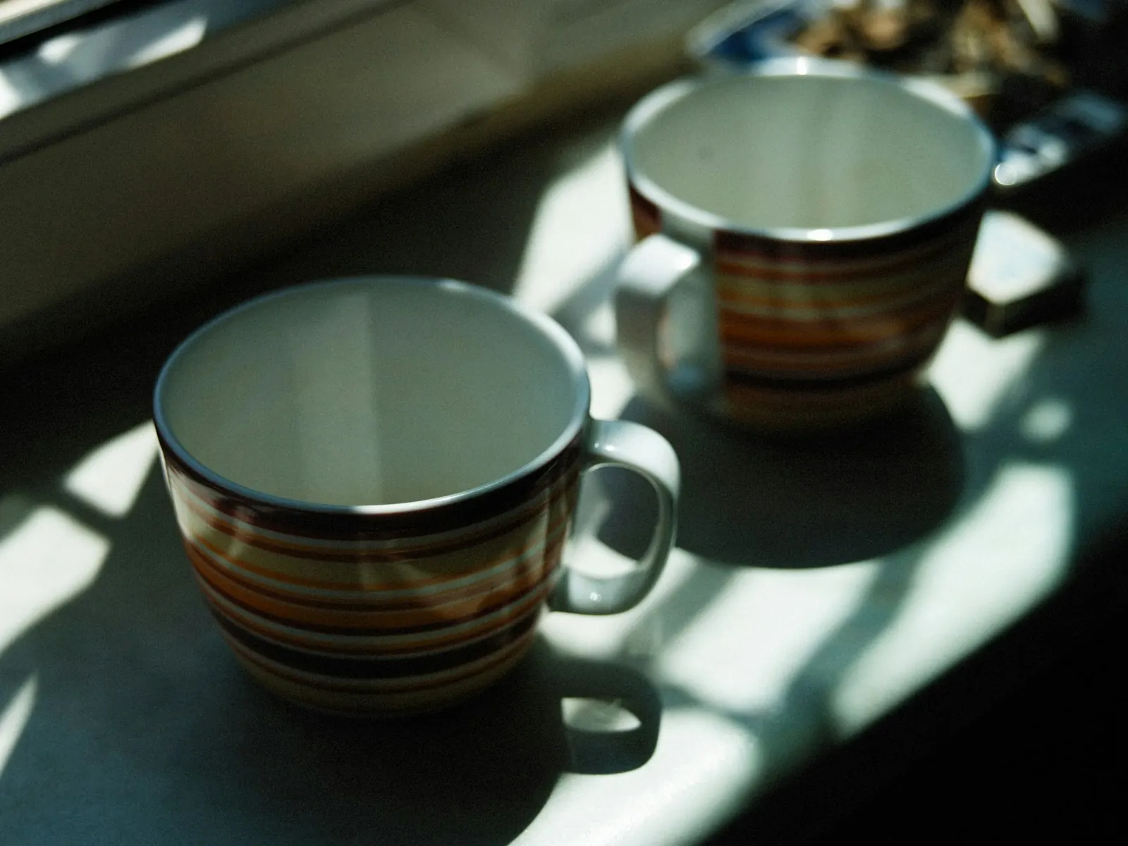Two mugs on the kitchen bench at the end of the day
