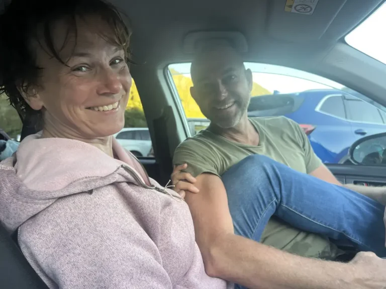Tarisha and Mark smiling together in the car