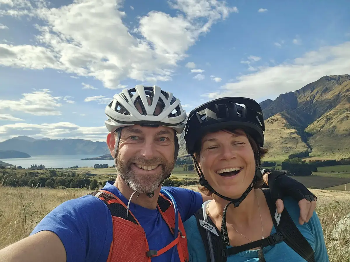 Mark and Tarisha laughing on a mountain bike ride near Wanaka