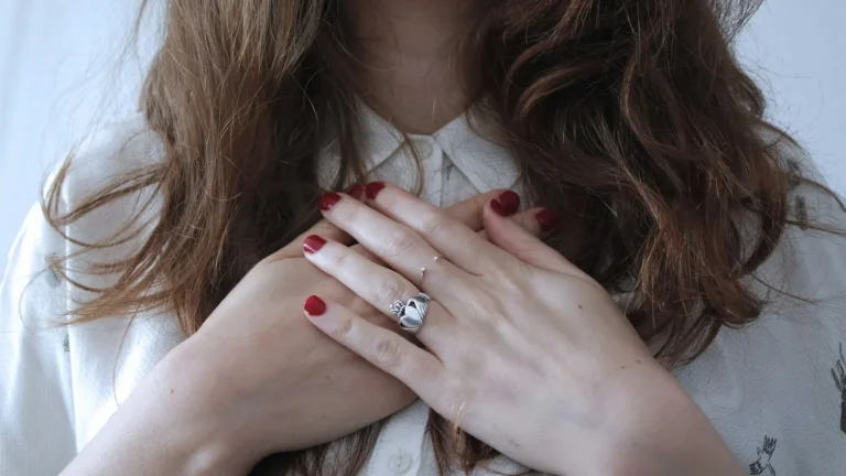 Woman resting her hands on her heart