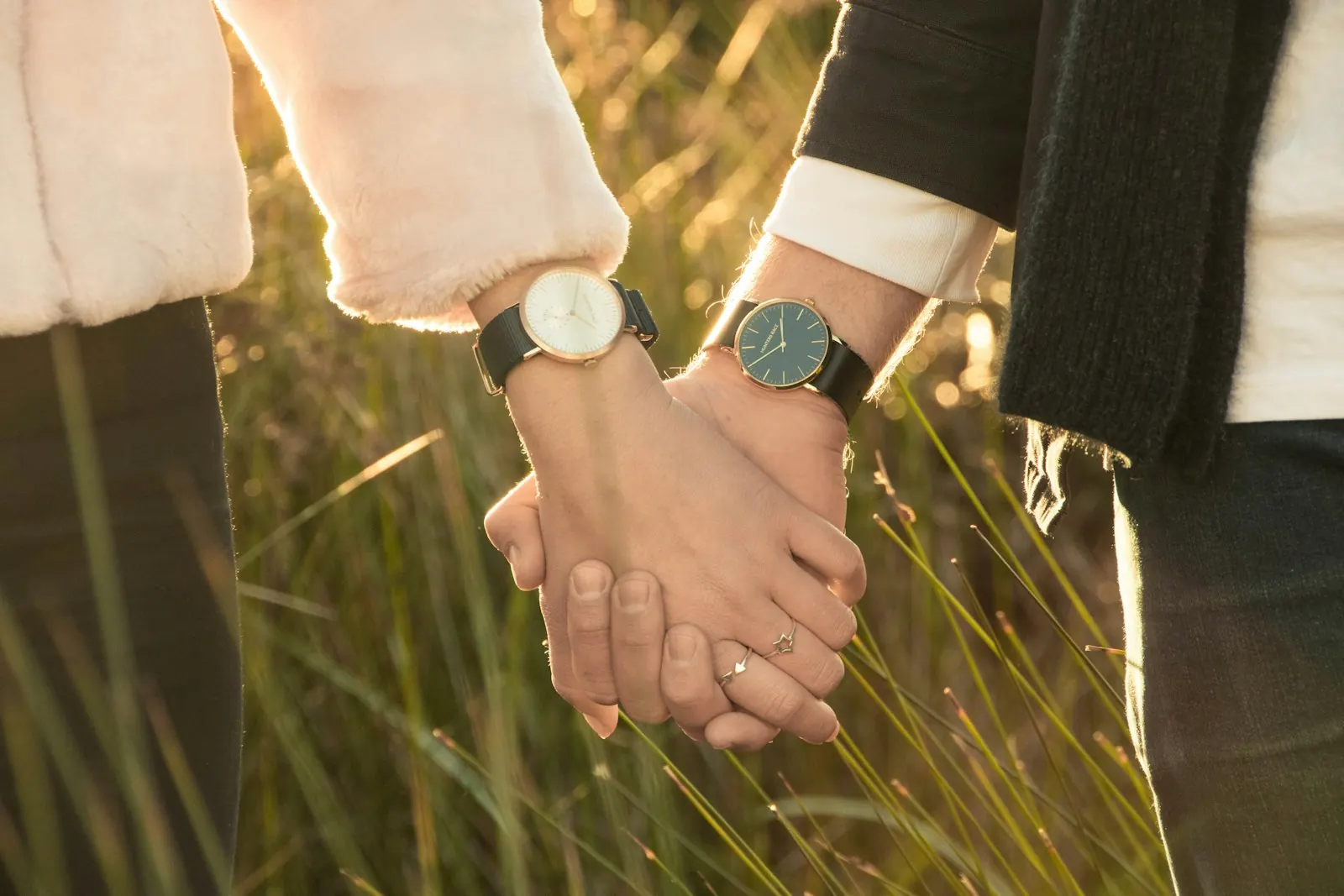 Couple holding hands in the long grass