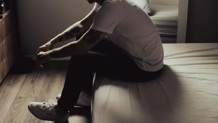 Man sitting on the edge of the bed