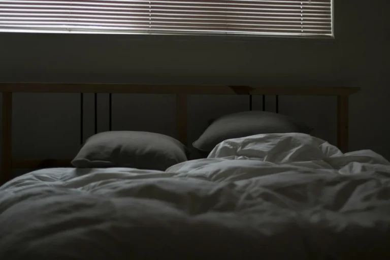 Empty unmade bed in soft light