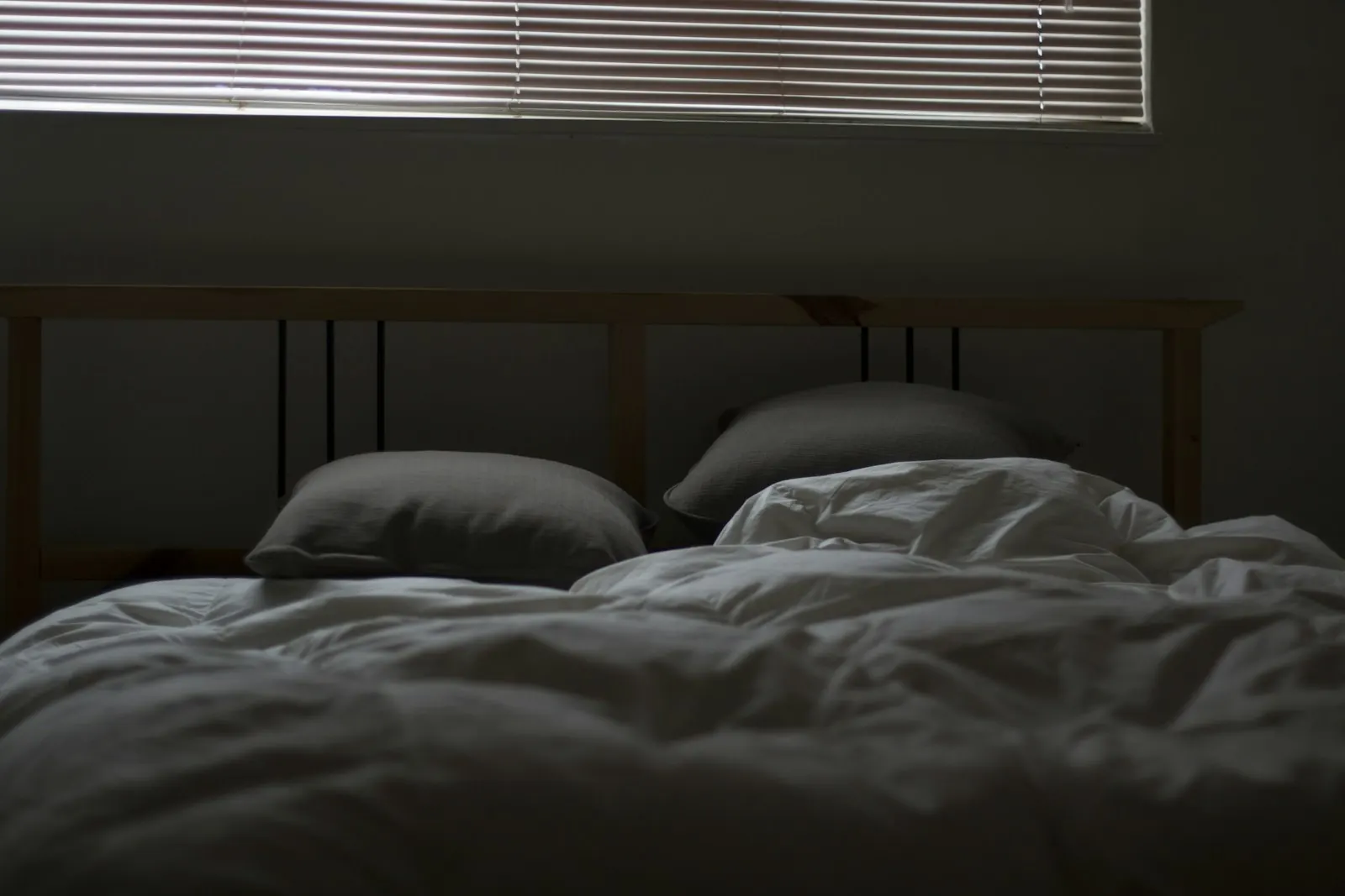 Empty unmade bed in soft light