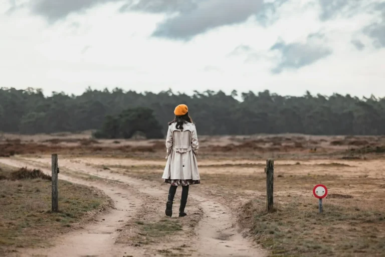 Woman standing where a path splits in two