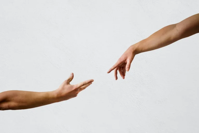 Two hands reaching towards each other