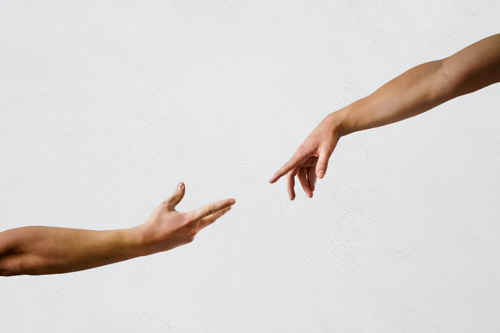 Two hands reaching towards each other