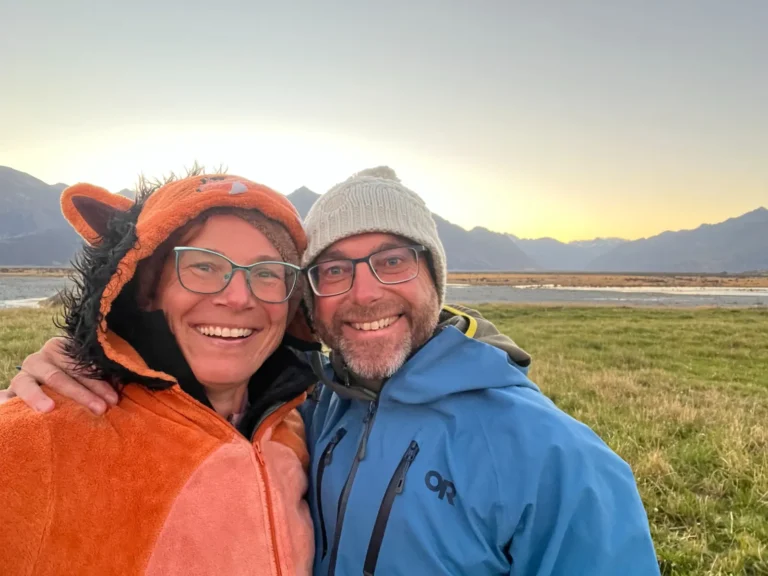 Tarisha and Mark smiling together at sunset
