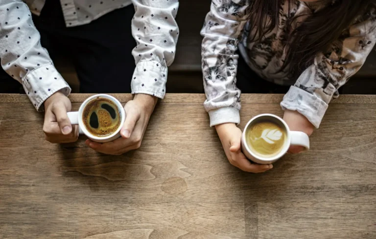 Couple sharing morning coffee at a wooden table