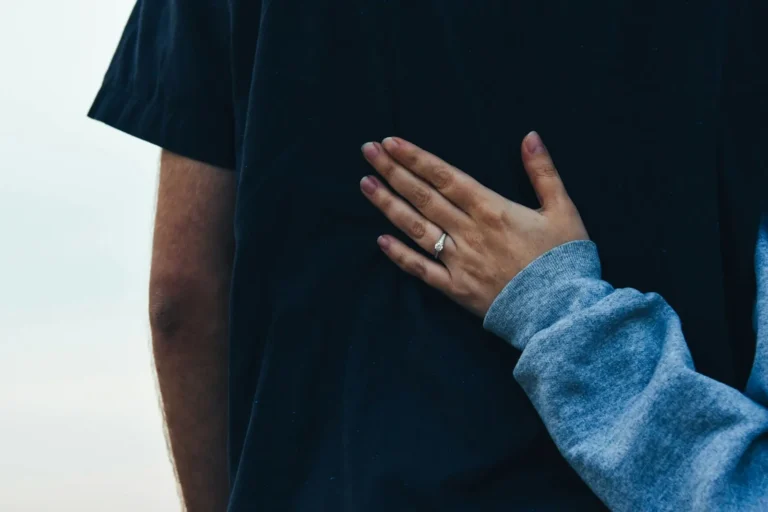 Hand resting on a partner's back in support