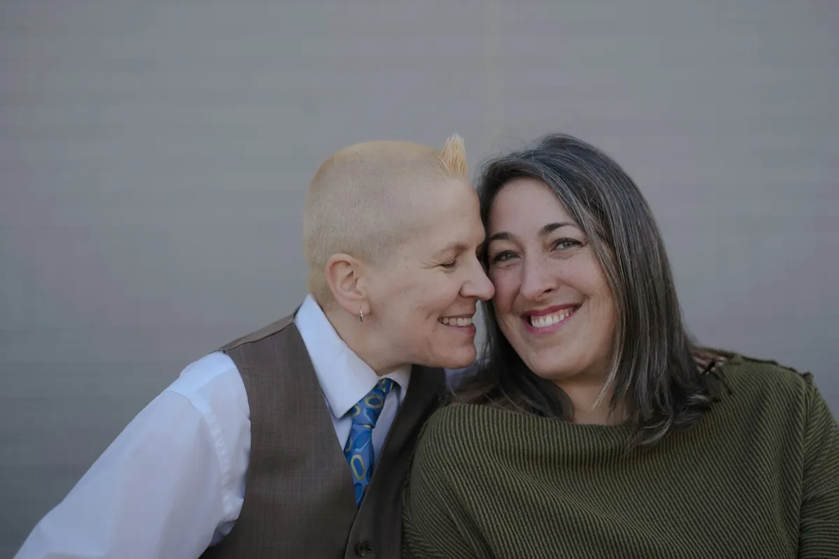 Two women hugging with heads together