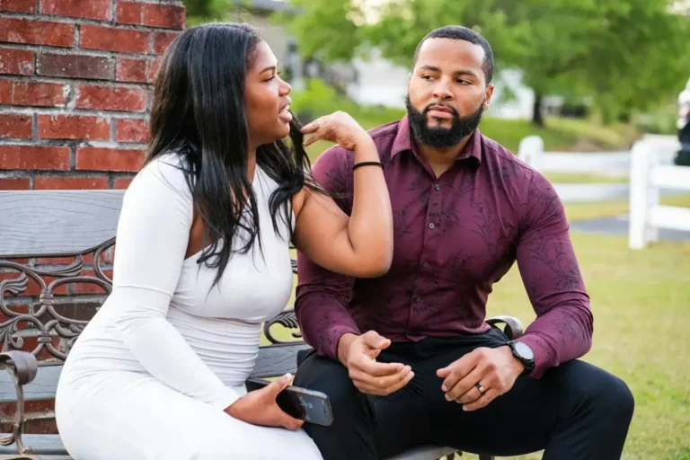 Couple sitting together outside, talking